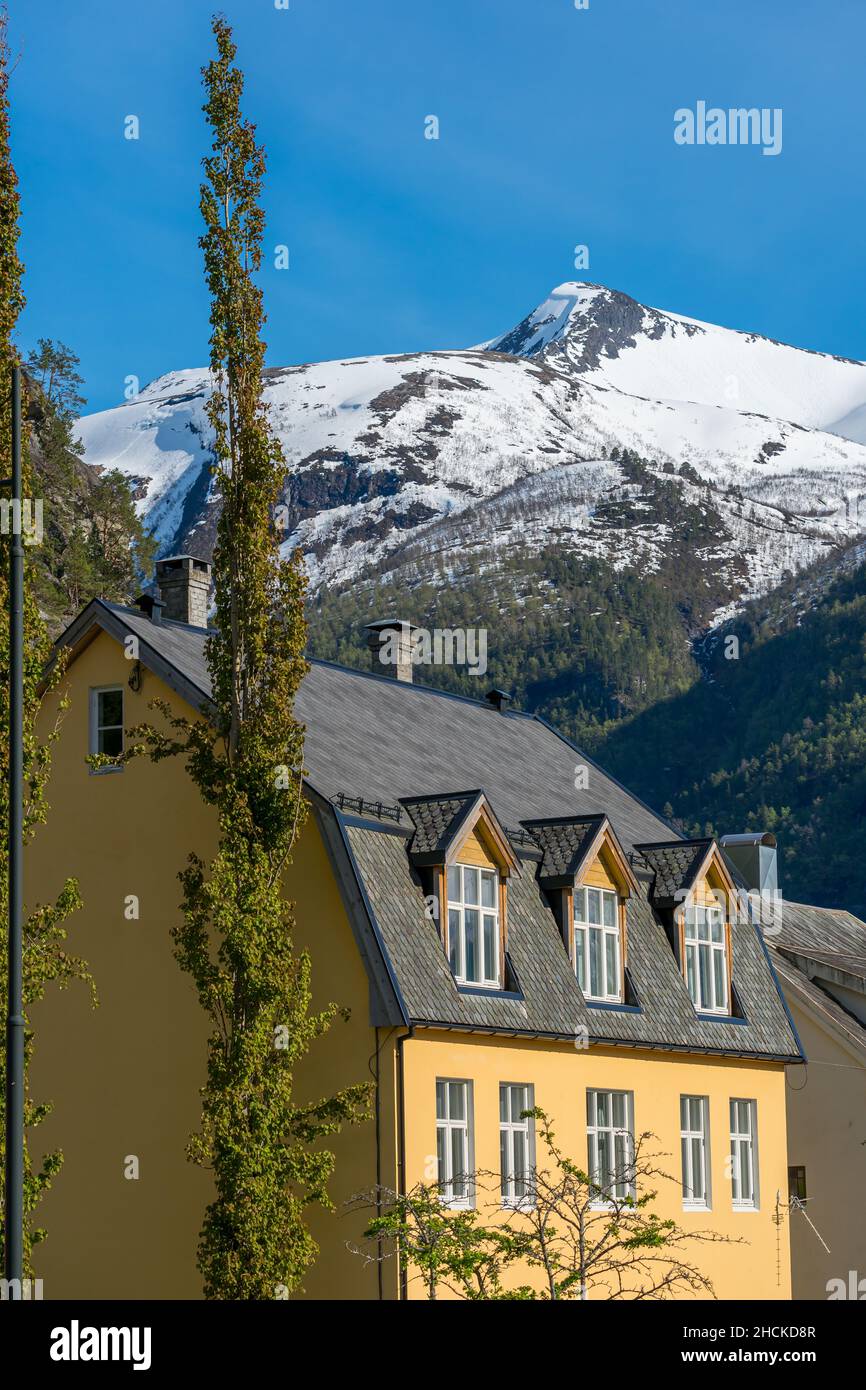 VALLDAL, NORWAY - 2020 MAY 29. Valldalen village house with mountains with snow on the background. Stock Photo