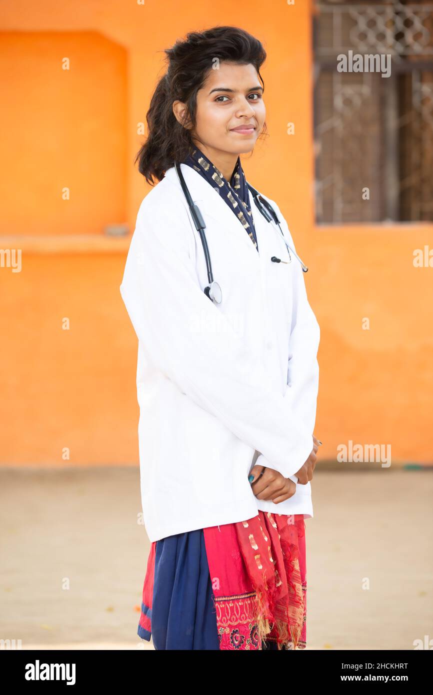 Portrait Of Young Smiling indian Female Doctor Wearing Stethoscope and Apron Standing, She is