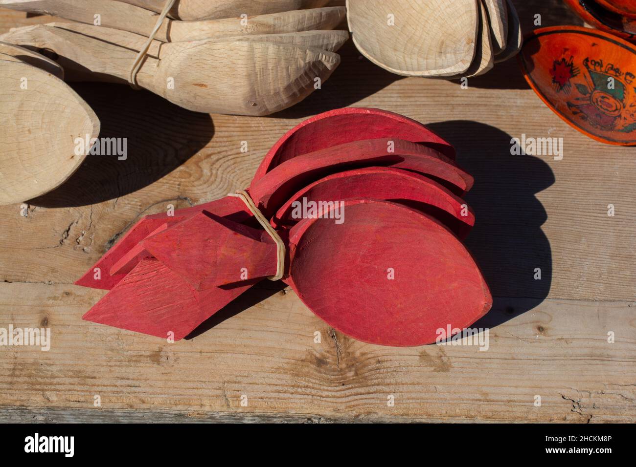 Top view of a tiled group of red wooden ancient spoon on a wooden bacjgroun Stock Photo
