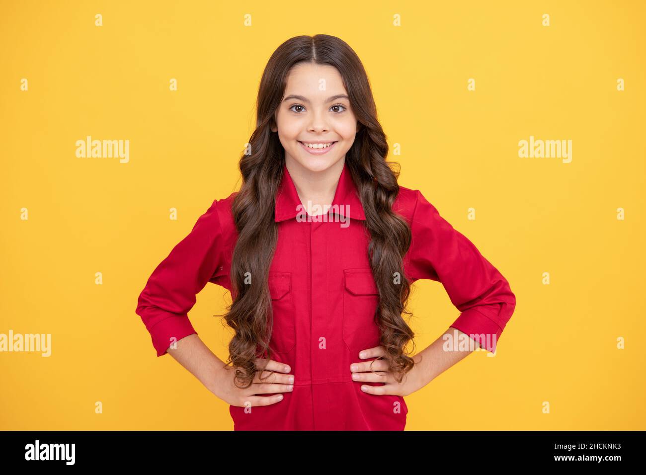 being self confident. happy childhood. cheerful teen girl with long curly hair. kid wear red shirt Stock Photo