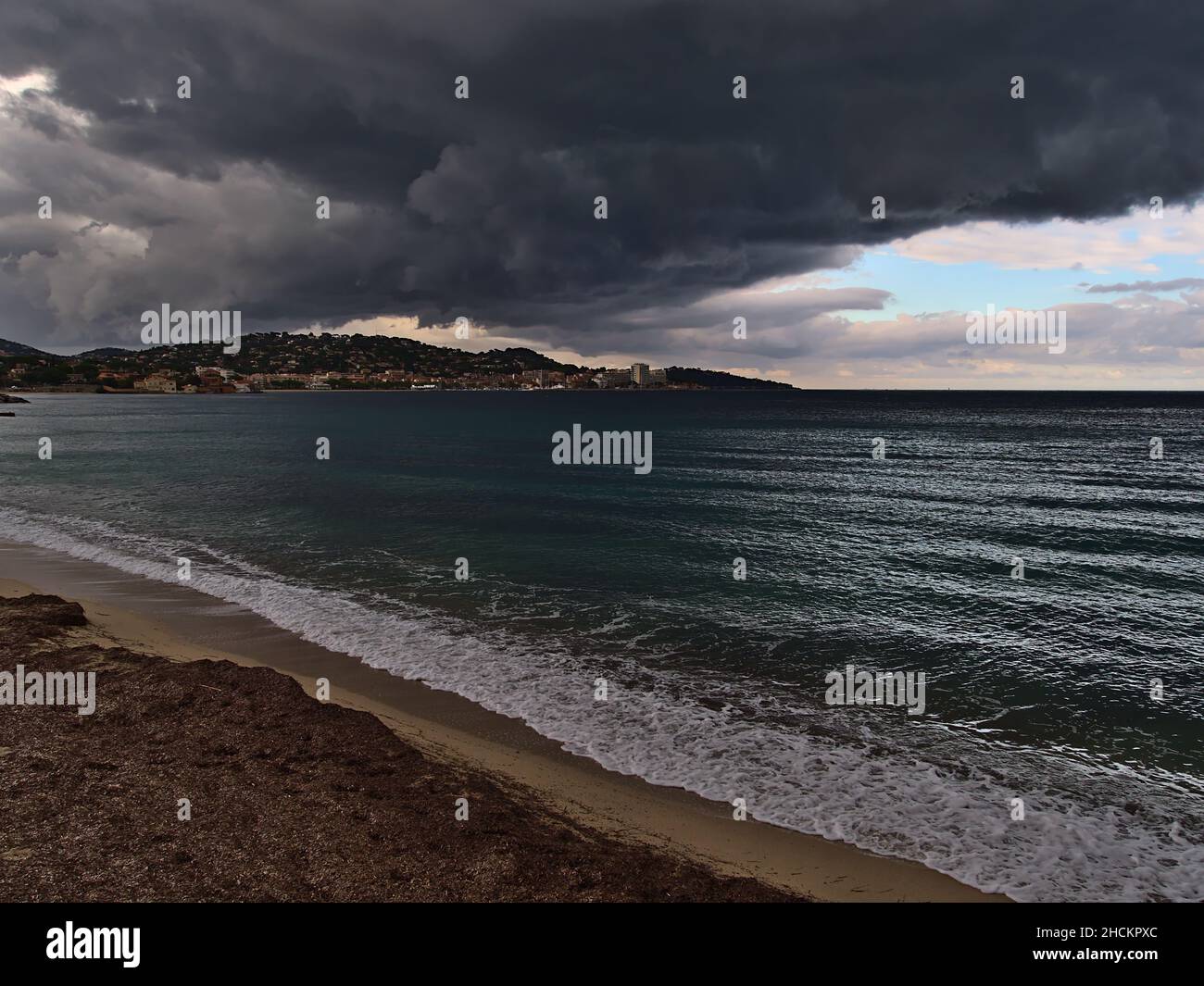 View of the northern shore of the Gulf of Saint-Tropez at the mediterranean coast on stormy day in autumn with town Sainte-Maxime at French Riviera. Stock Photo