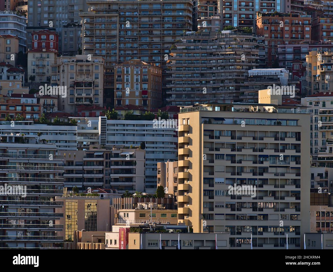 View of dense residential development in the city of Monaco at the French Riviera in the afternoon sun with luxury high-rise apartment buildings. Stock Photo
