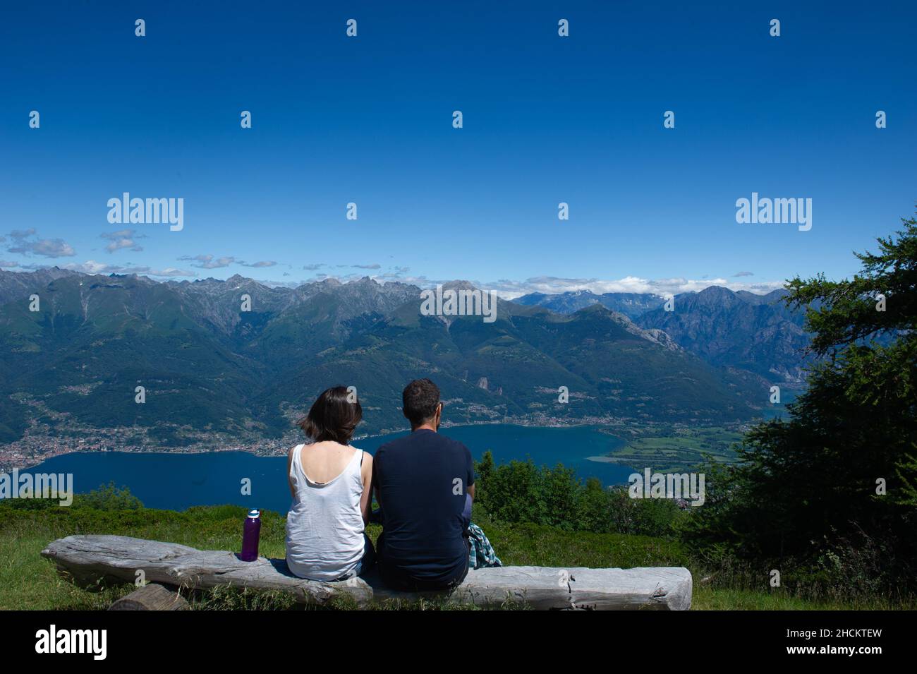 Europe, Italy, Lombardy, Lecco province, Wooden bench on the top of Mount Legnoncino overlooking Lake Como. Stock Photo