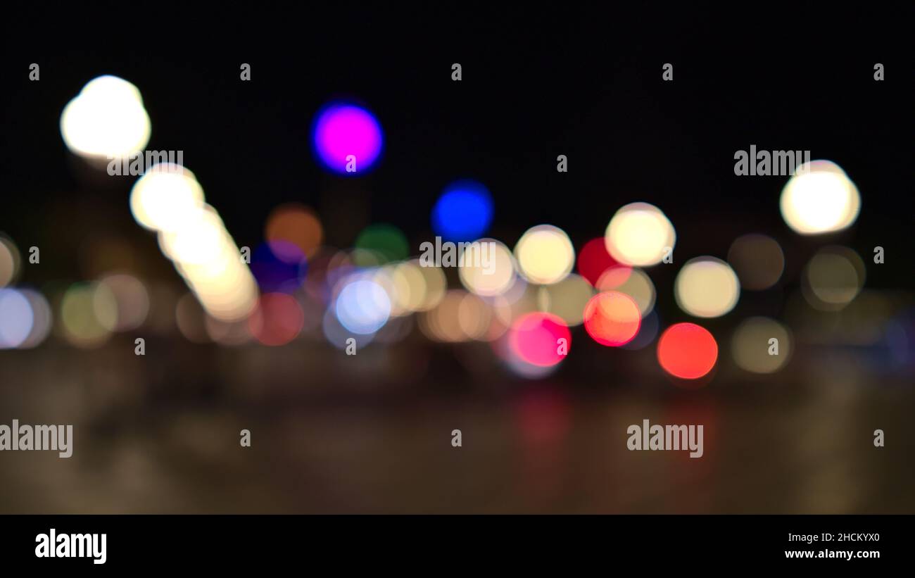 Defocussed (blurred) view of town square Place Massena in the center of Nice, France at the French Riviera with colorful street lights by night. Stock Photo