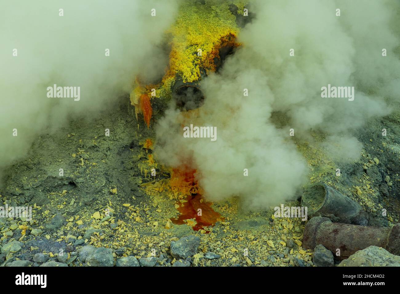 Molten sulfur dripping from pipes at Kawah Ijen volcano, East Java ...