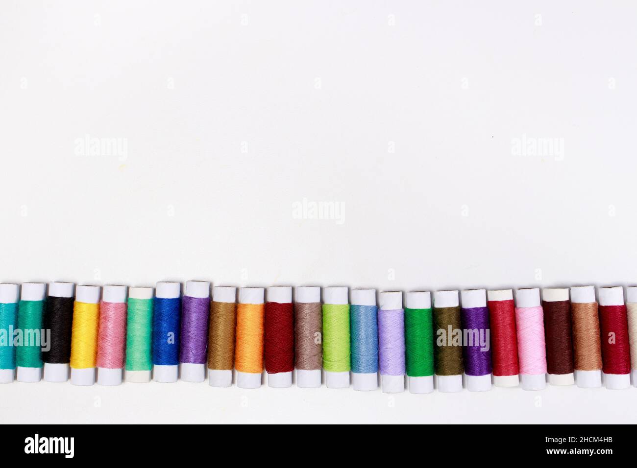 Set of multi-colored skeins of thread on a white background with place ...