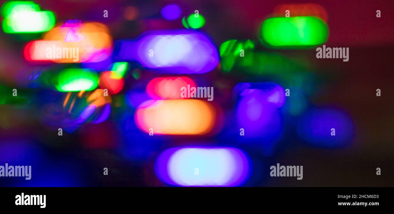 Abstract blurred dark background with colored lights. Stock Photo
