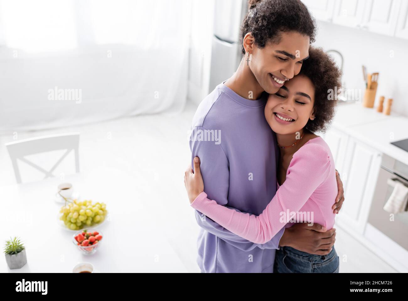 Young african american couple hugging near fruits in kitchen Stock ...