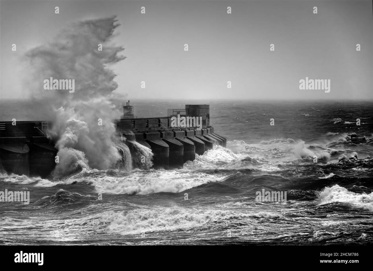 Waves crashing against marina arm Stock Photo