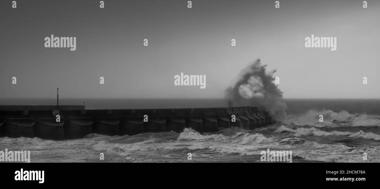 heart shape in waves crashing over marina arm Stock Photo