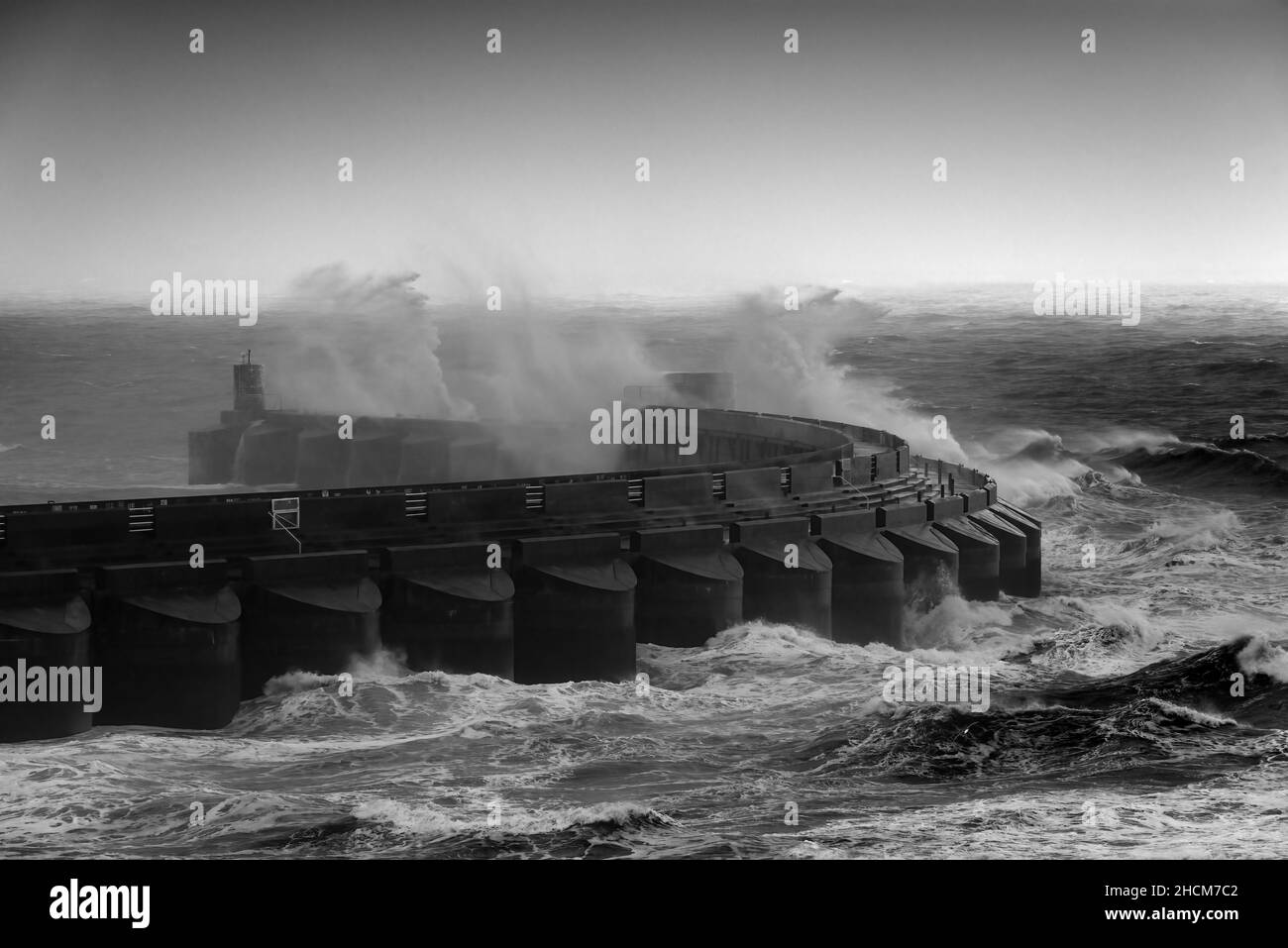 Waves crashing against marina arm Stock Photo