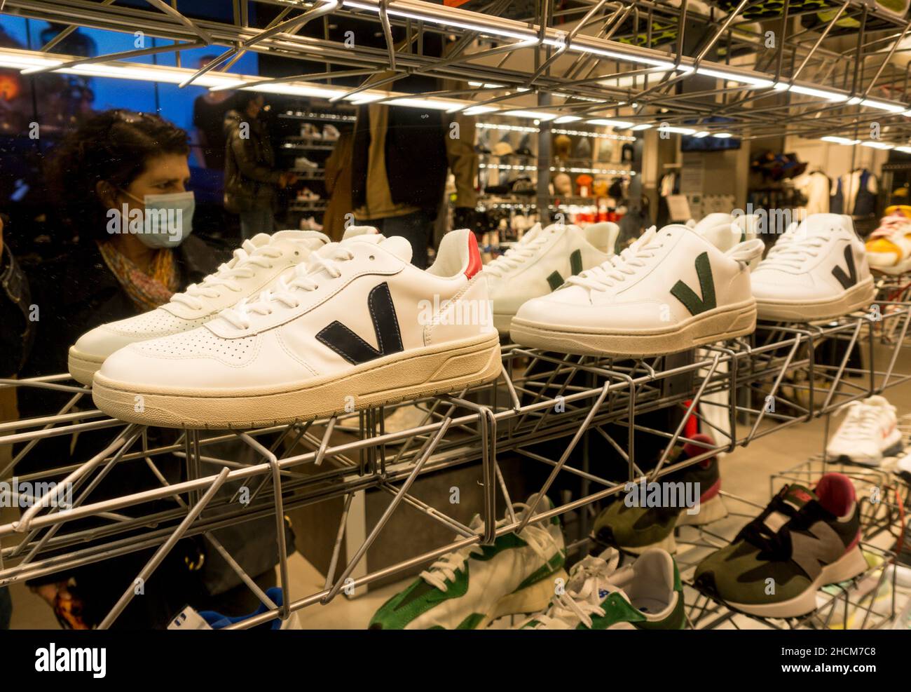 A row of Vegan sneakers on display in sports shop. Spain. Stock Photo