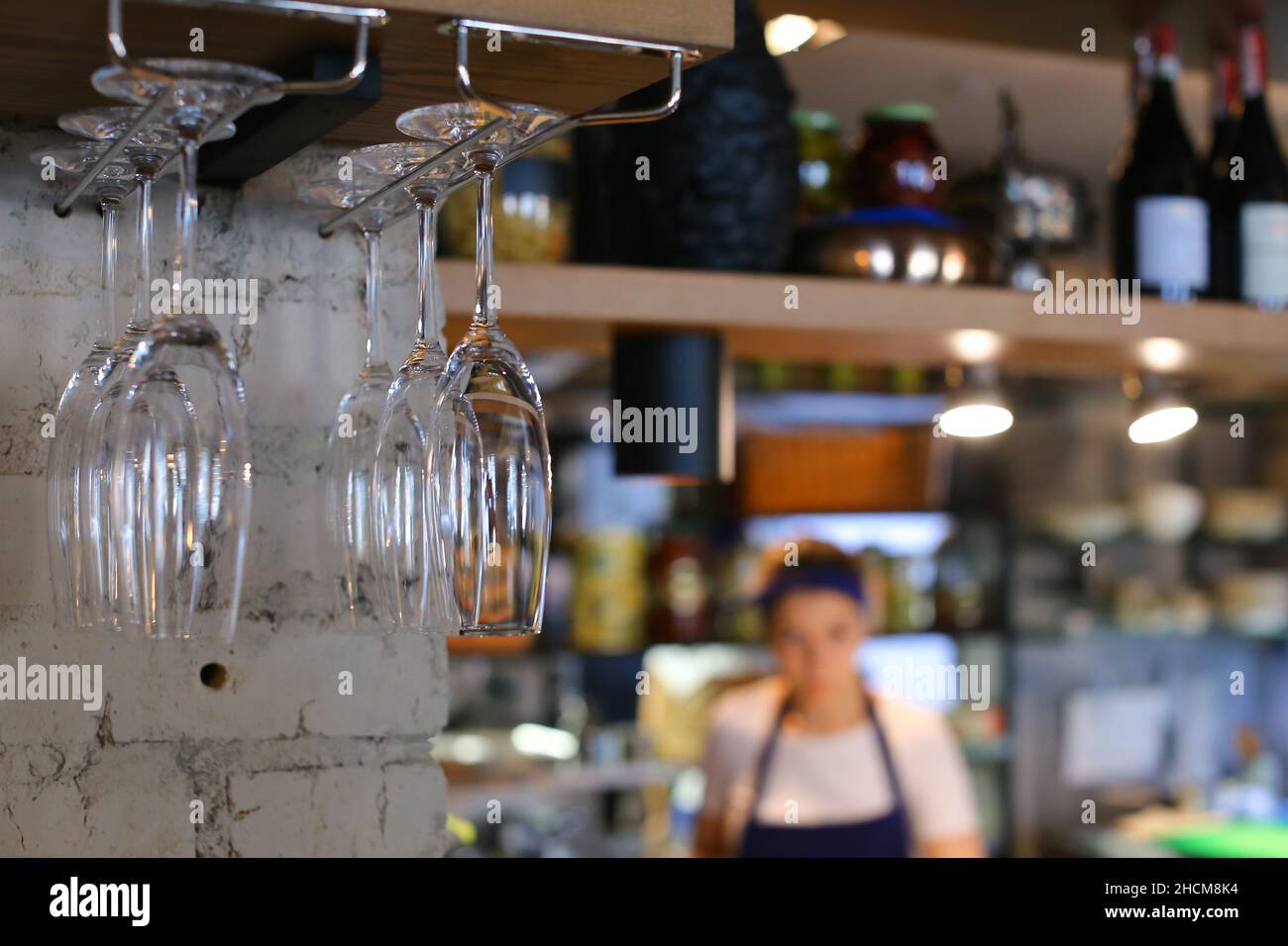 Glasses hanging upside down in cafe restaurant wine Stock Photo