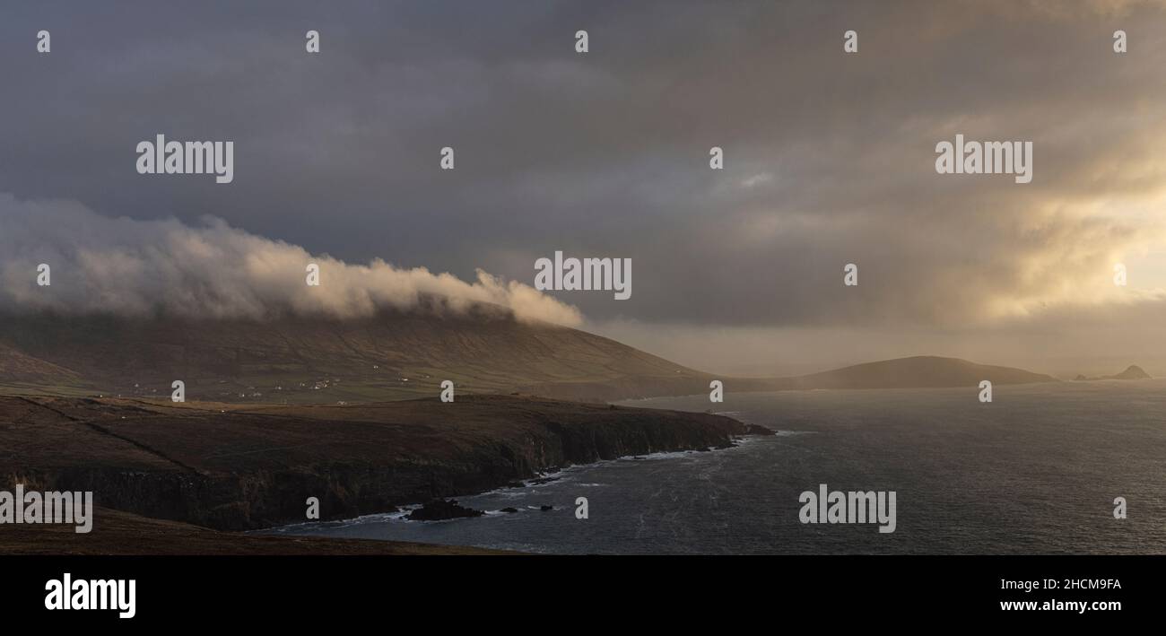 Clouds over Dunmore Head viewed from Clogher Head at sunset on the Dingle Peninsula, County Kerry, Ireland Stock Photo