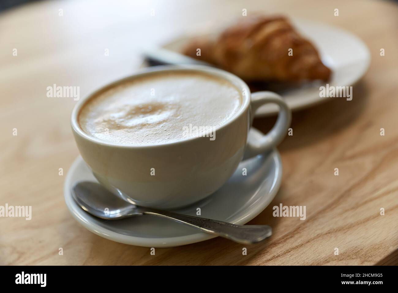 COFFEE CUP WITH CROISSANT Stock Photo