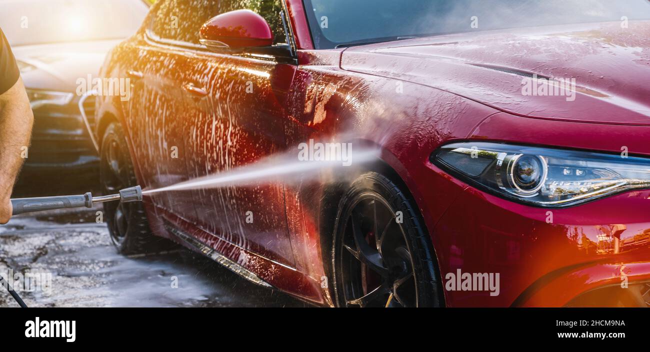 Cleaning red Car Using High Pressure Water in a Car Wash Stock Photo Alamy