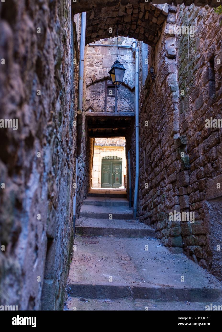 A passageway in the town of Joyeuse located in Southern France, taken on a sunny summer morning with no people Stock Photo