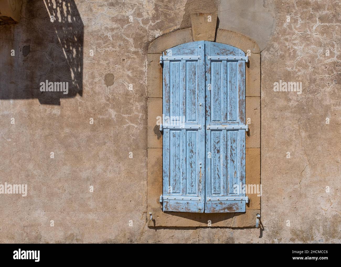 A pale blue window on an historical house in the Southern France town of Joyeuse, Ardeche, taken on a sunny summer morning with no people Stock Photo
