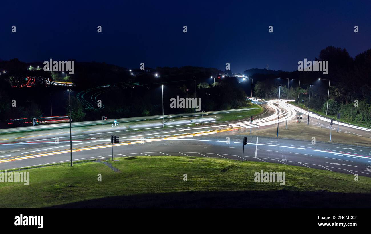 Road to the city with busy traffic taillights at night Stock Photo