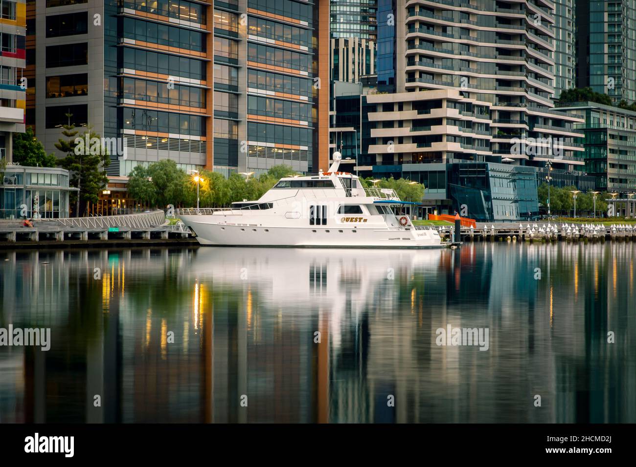 Beautiful white yacht and skyscrapers background reflection in the water in Melbourne, Australia Stock Photo