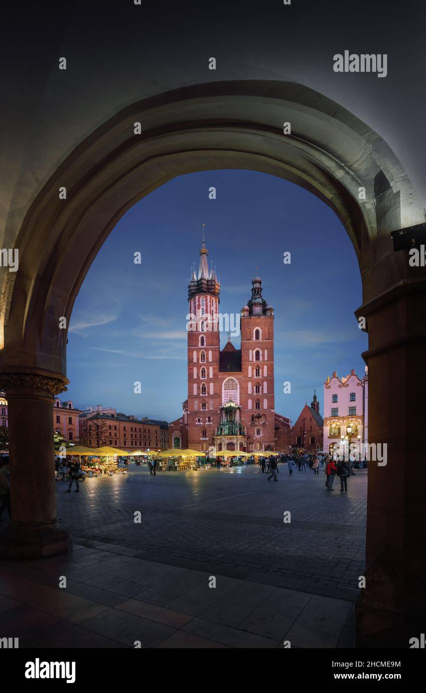 St. Mary's Basilica and Cloth Hall Arches at night - Krakow, Poland Stock Photo