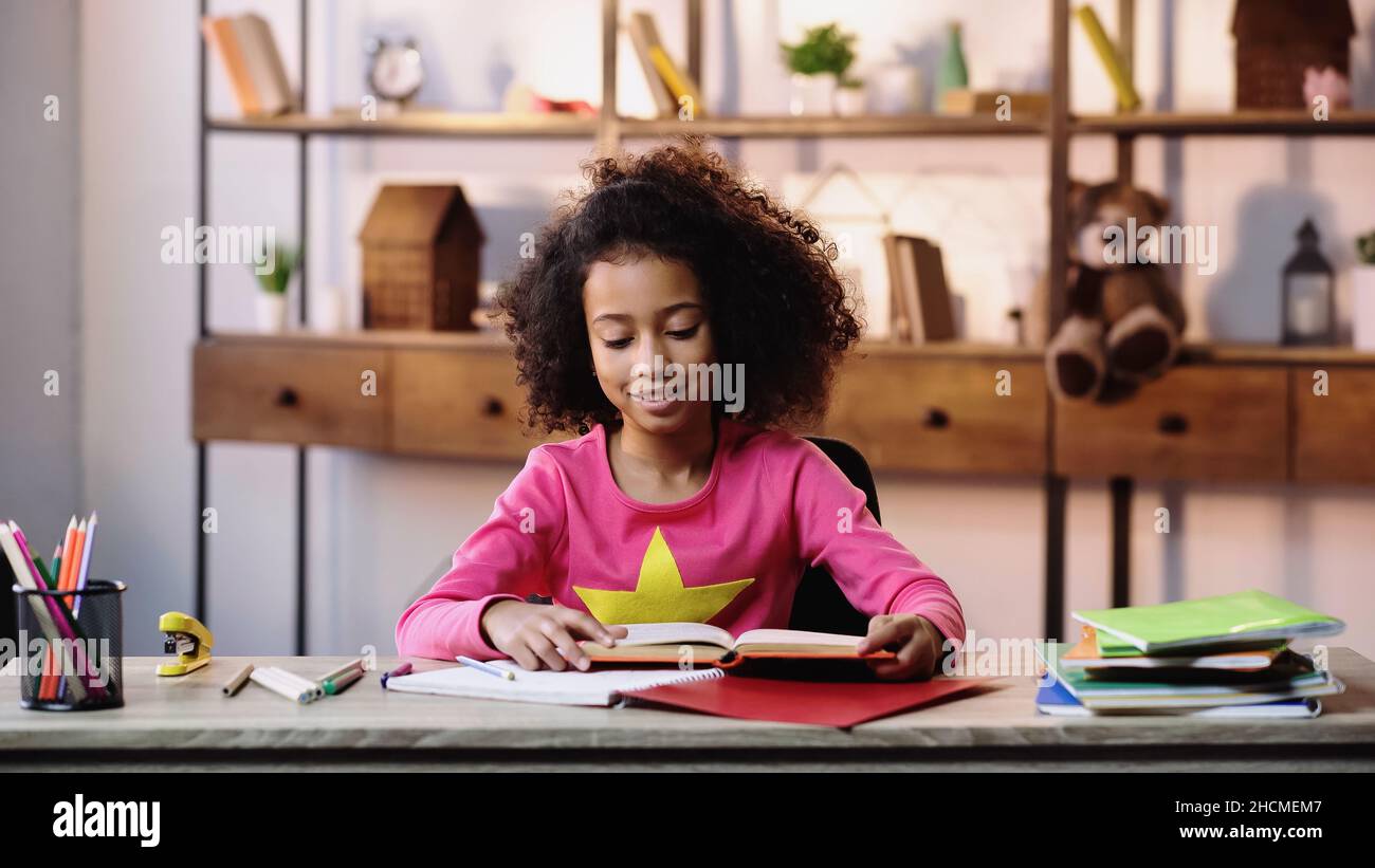 African american girl reading table hi-res stock photography and images ...