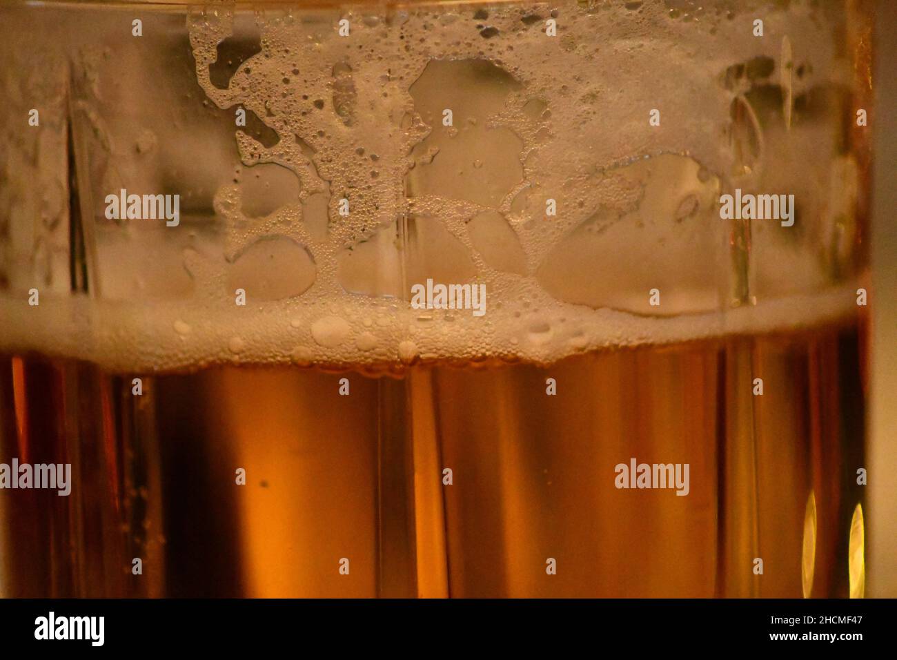 A glass of real ale showing the reduction of froth as the ale is drunk Stock Photo