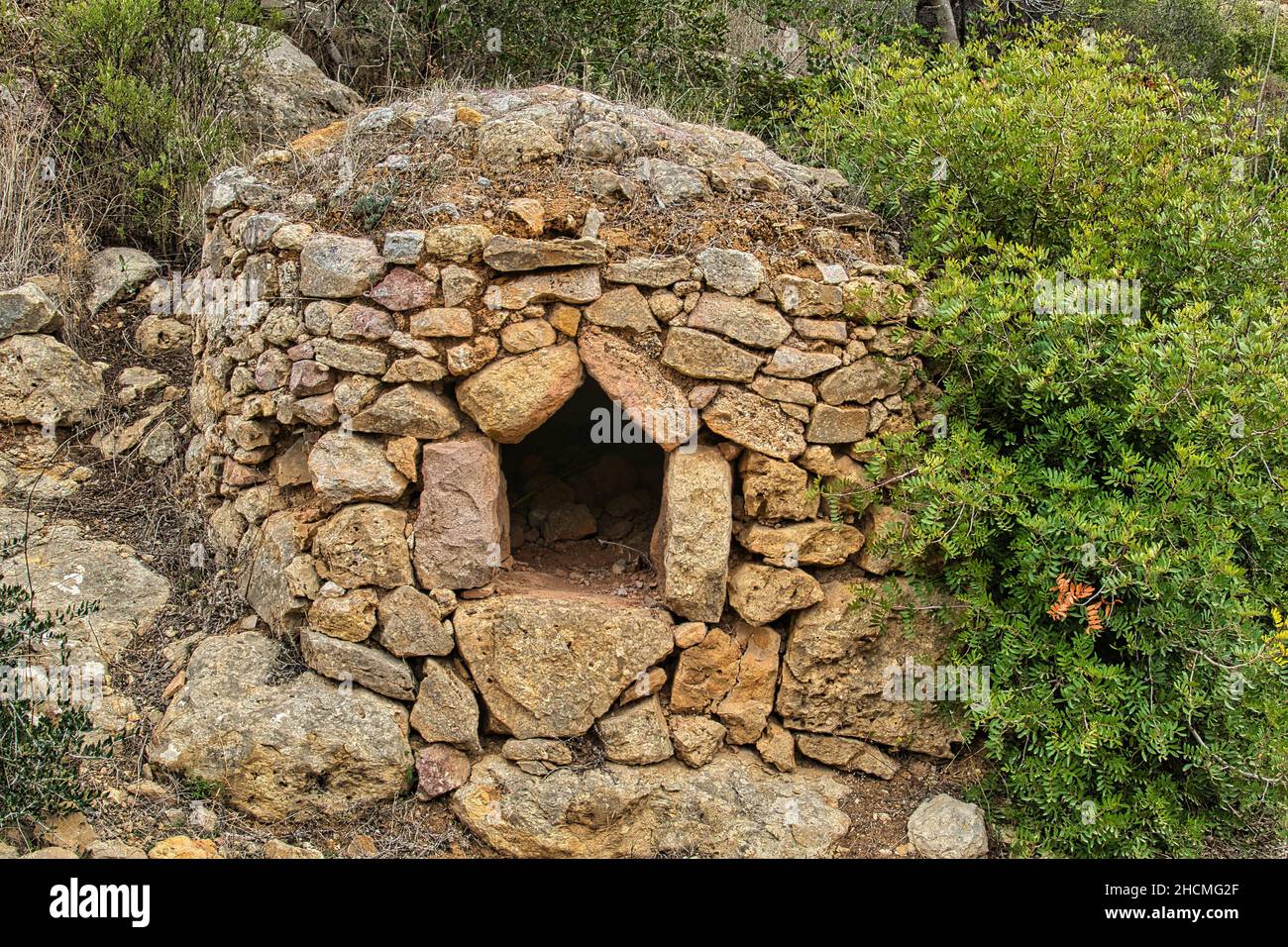 Old, but well preserved round oven, built from blocks of natural stone, in the Mediterranean forest near Paderne, Algarve, Portugal Stock Photo
