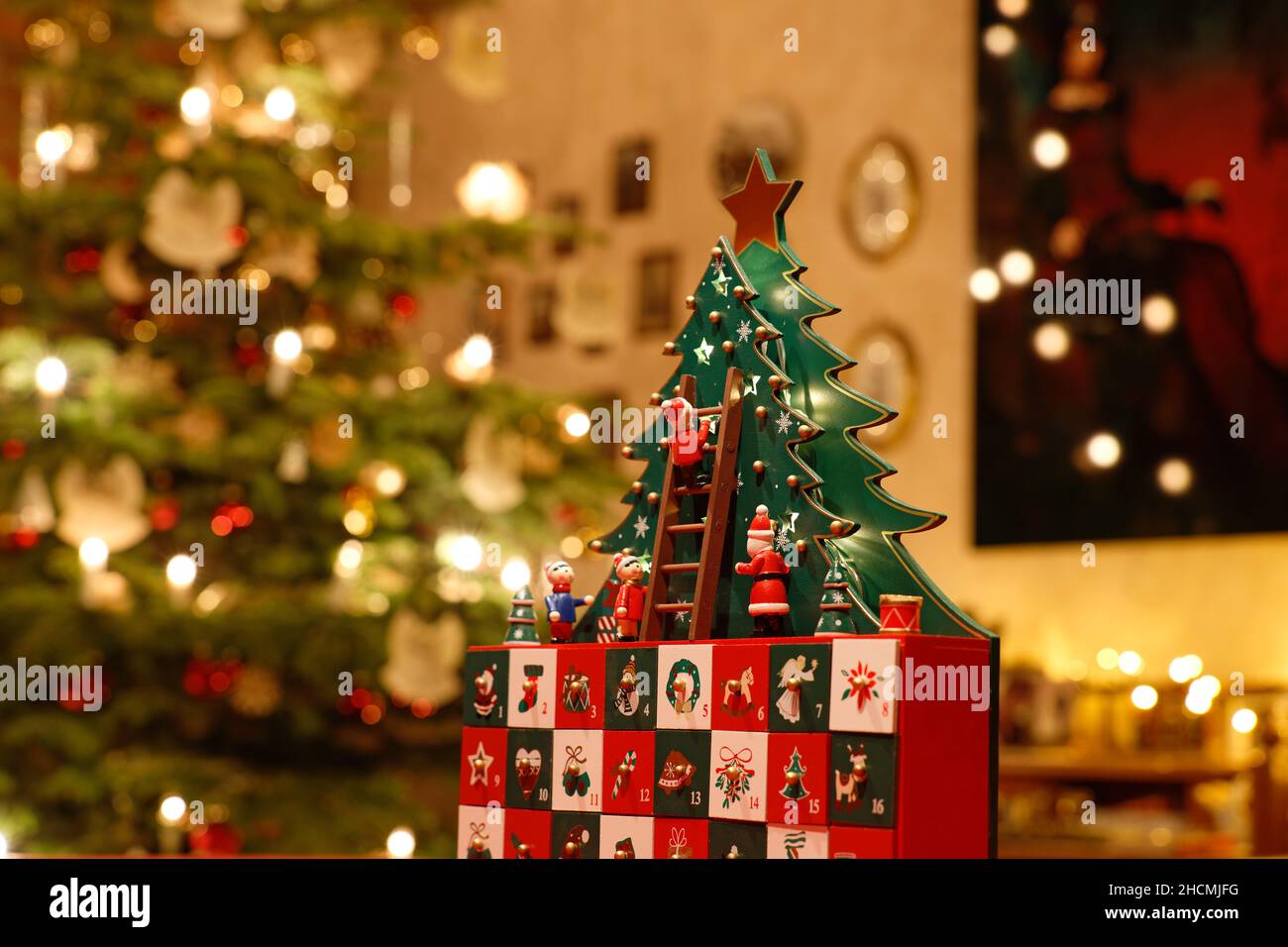 Three-dimensional Advent Calendar with stylised Christmas Tree in the middle of Christmassy decorated Family Room Stock Photo