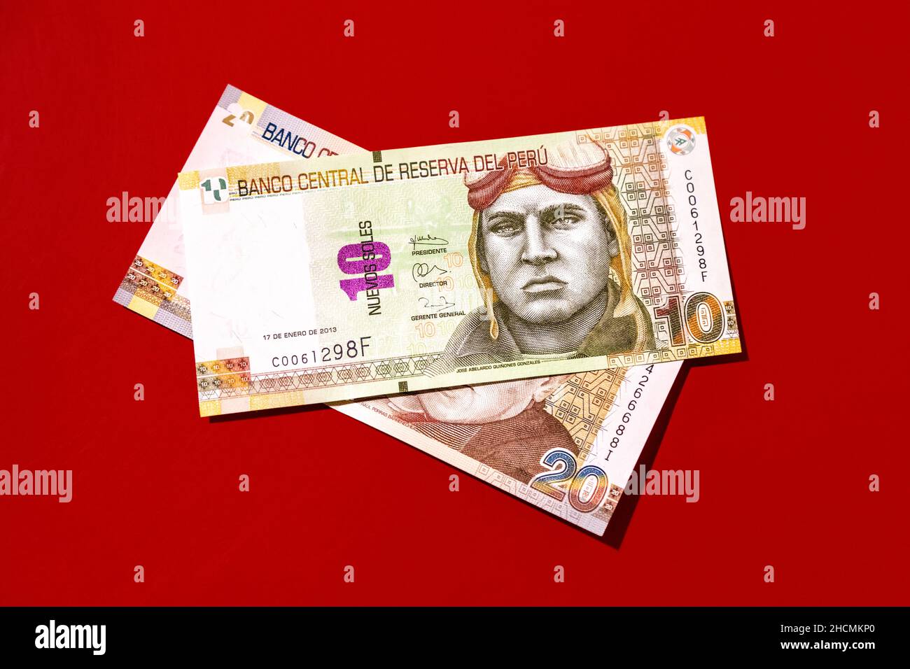 10 and 20 Peruvian Sol notes, Peruvian money against red background Stock Photo