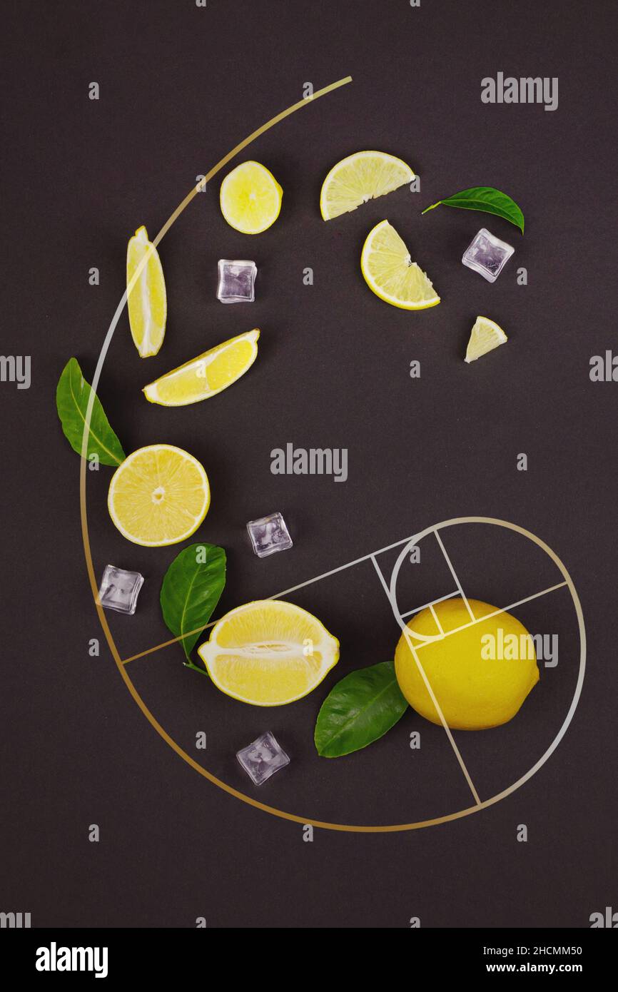 Fresh slices of yellow lemon lime fruit with green leaf and ice cube