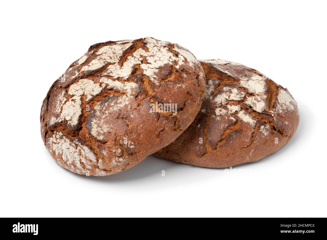 Pair of fresh baked German sourdough loaf of bread with rye and wheat flours isolated on white background Stock Photo