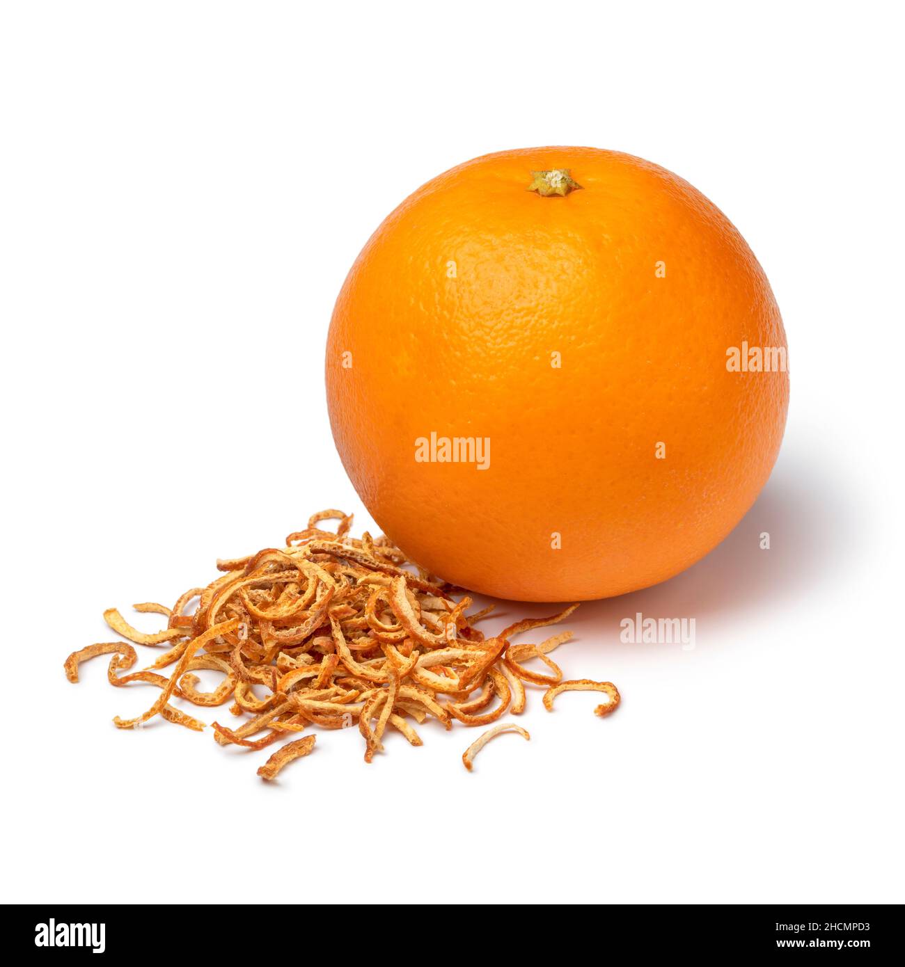 Heap of dried bitter orange peel and an orange isolated on white