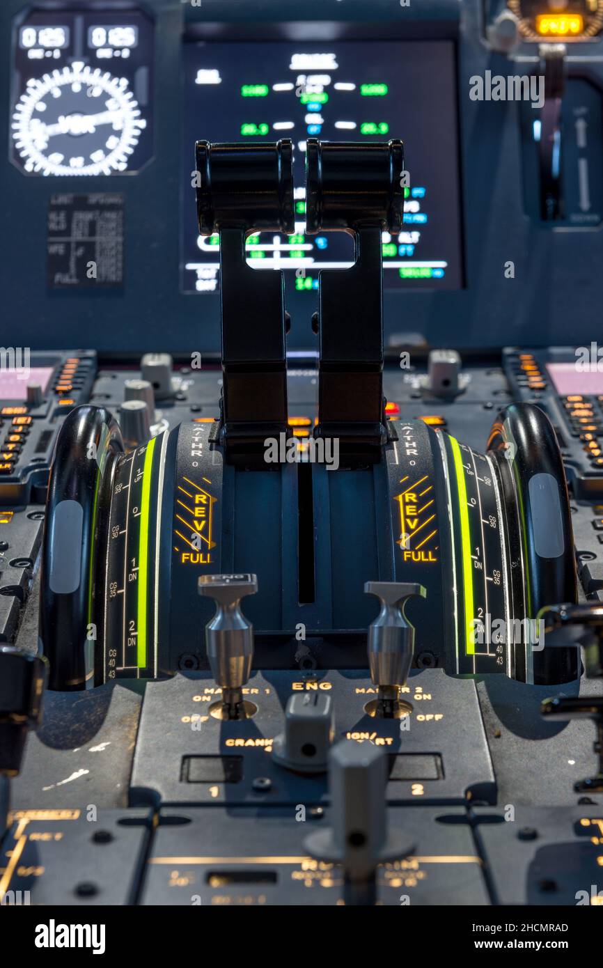 Engines thrust levers inside a big jet plane cockpit. Stock Photo