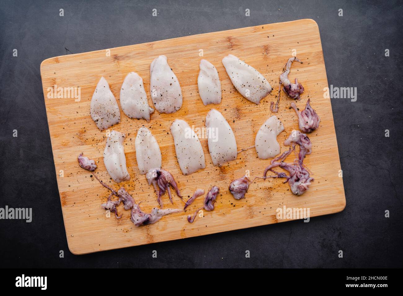 Raw Squid Tubes and Tentacles Seasoned with Salt and Pepper Uncooked
