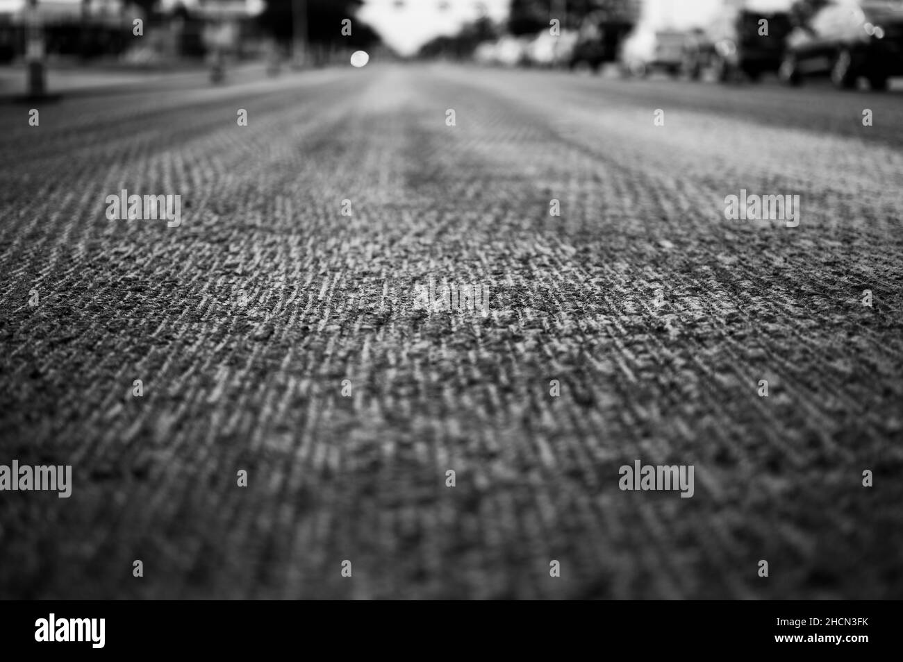 Low angle shot across a scarified street under construction with lanes on either side blocked off. Stock Photo