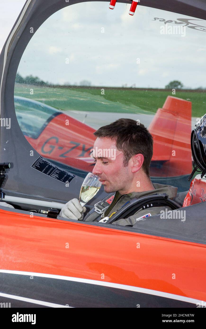 Jason Phelan completing an aerobatic challenge for the fly2help charity, having been flown by numerous aerobatic teams and pilots. Fundraiser Stock Photo