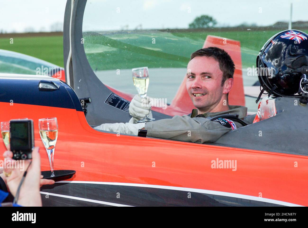 Jason Phelan completing an aerobatic challenge for the fly2help charity, having been flown by numerous aerobatic teams and pilots. Fundraiser Stock Photo