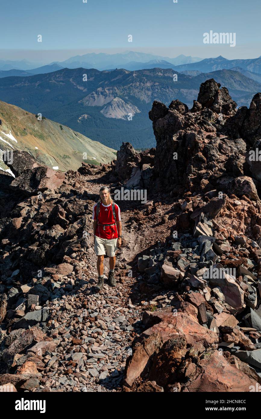 WA19945-00...WASHINGTON - Day hiker on the Alternate Pacific Crest Trail south of Elk Pass in the Goat Rocks Wilderness. Stock Photo