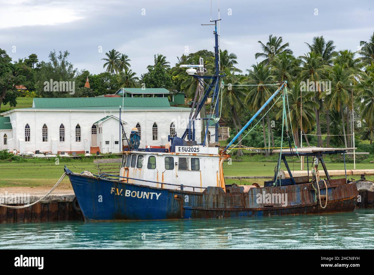 The small port on the island of Aitutaki with the christian church in the background, Cook Islands, South Pacific Stock Photo