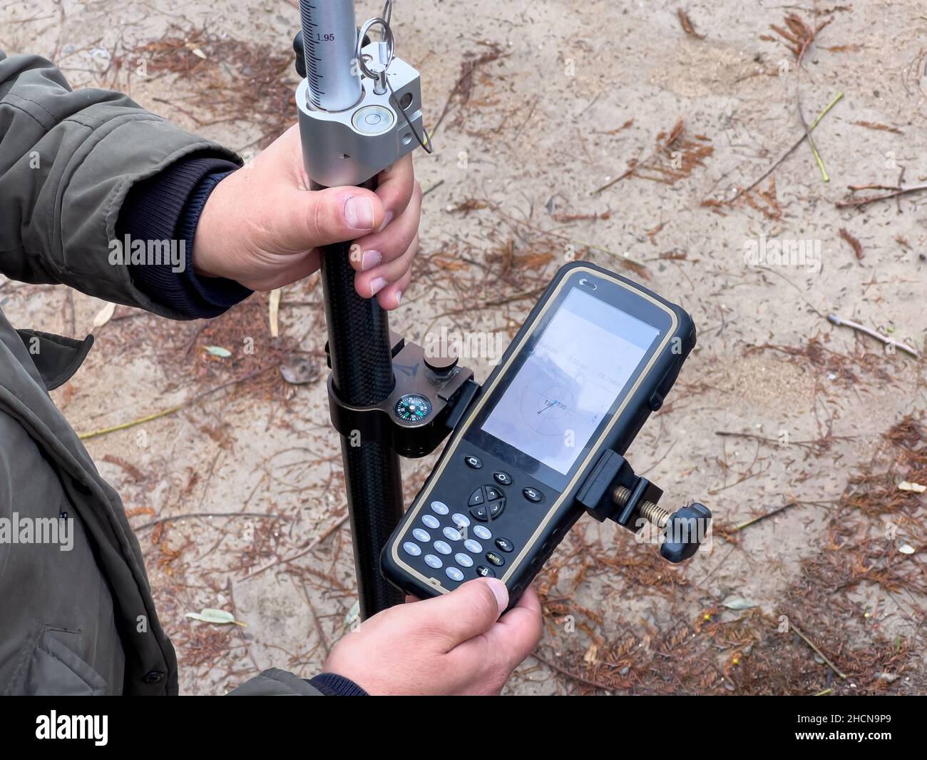 Engineer and Surveyor reviewing the GPS system and total station data using the GPS application. Stock Photo