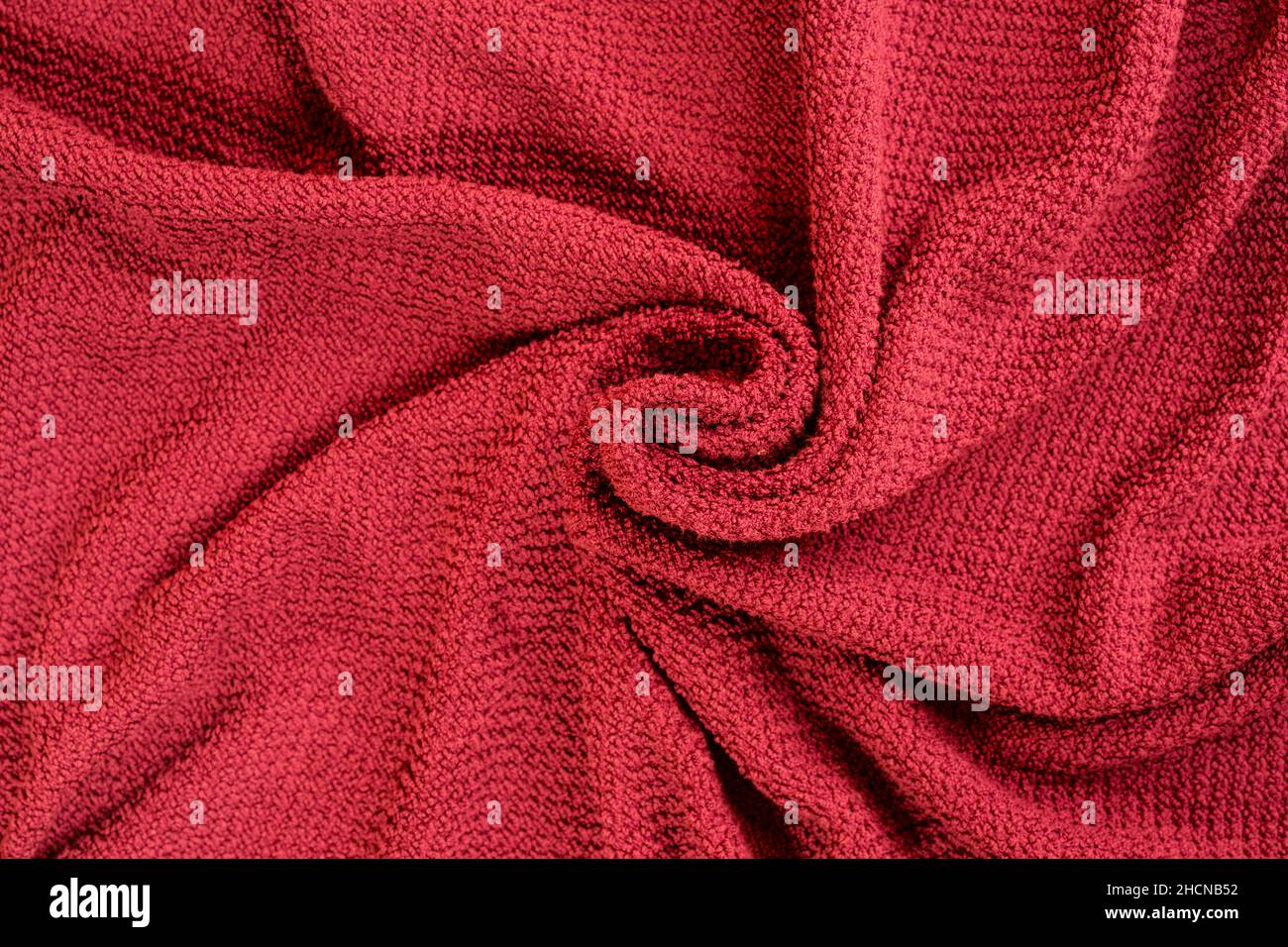 a red towel wrapped in a spiral Stock Photo