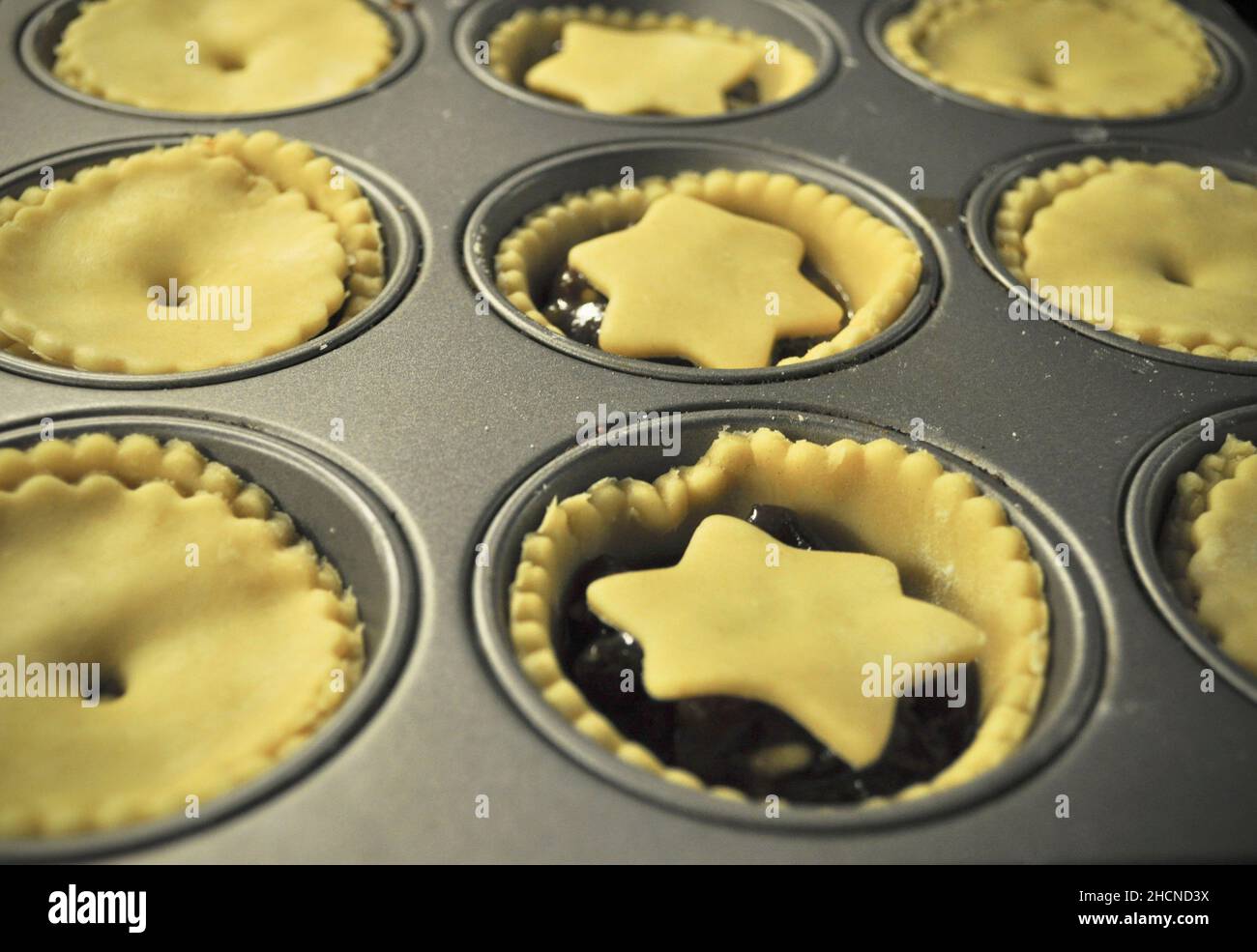 Homemade, deep filled mince pies ready to be baked in the tray Stock Photo