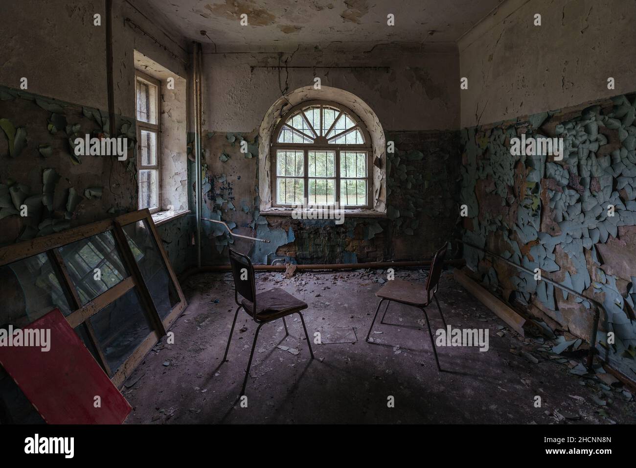 Inside old Asylum for the insane. Dark creepy abandoned mental hospital Stock Photo