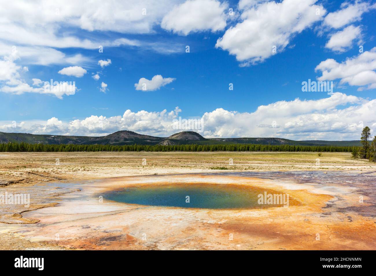 Midway geyser basin Opal Pool under sunny sky at Yellowstone National Park, Wyoming, USA Stock Photo