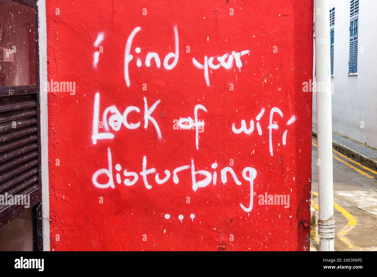 SINGAPORE, SINGAPORE - MARCH 10, 2018: Text I wind your lack of wifi disturbing written on a wall in Singapore. Stock Photo
