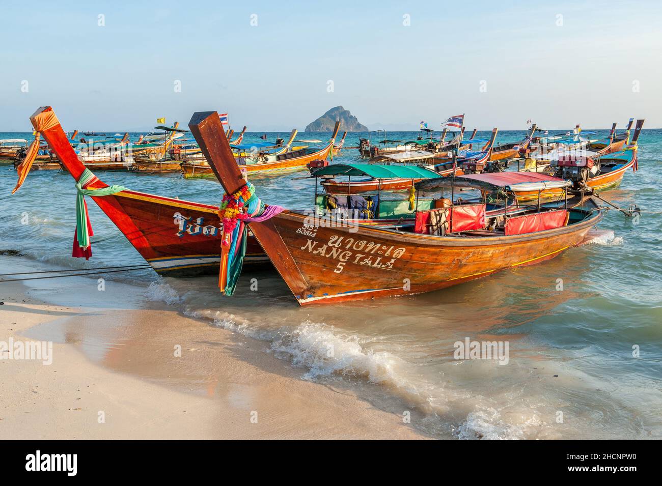 Longtail boats at Laem Tong Beach on Phi Phi Islands. These tropical islands are a popular tour destination from Phuket and Krabi in Thailand. Stock Photo
