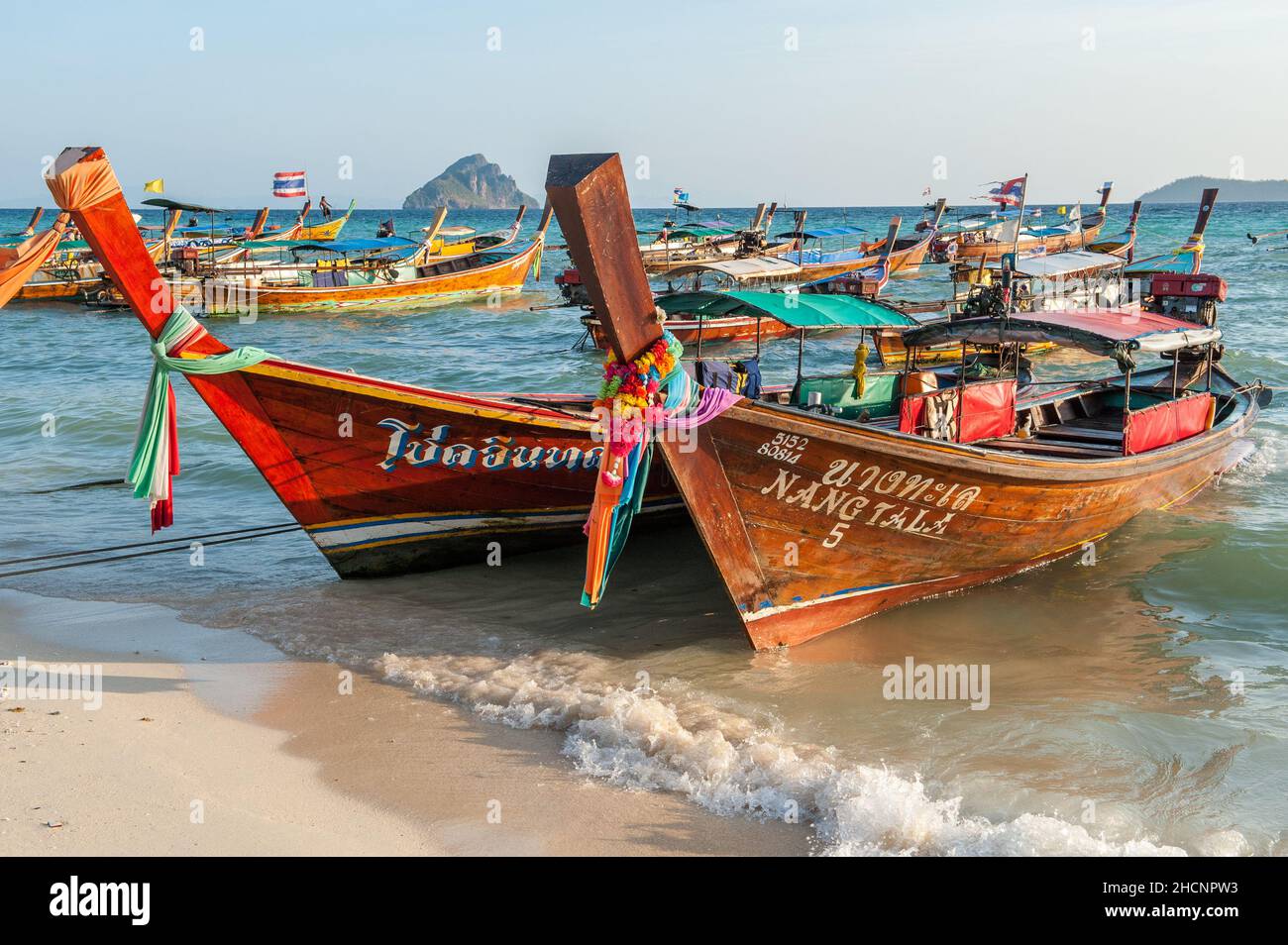 Longtail boats at Laem Tong Beach on Phi Phi Islands. These tropical islands are a popular tour destination from Phuket and Krabi in Thailand. Stock Photo