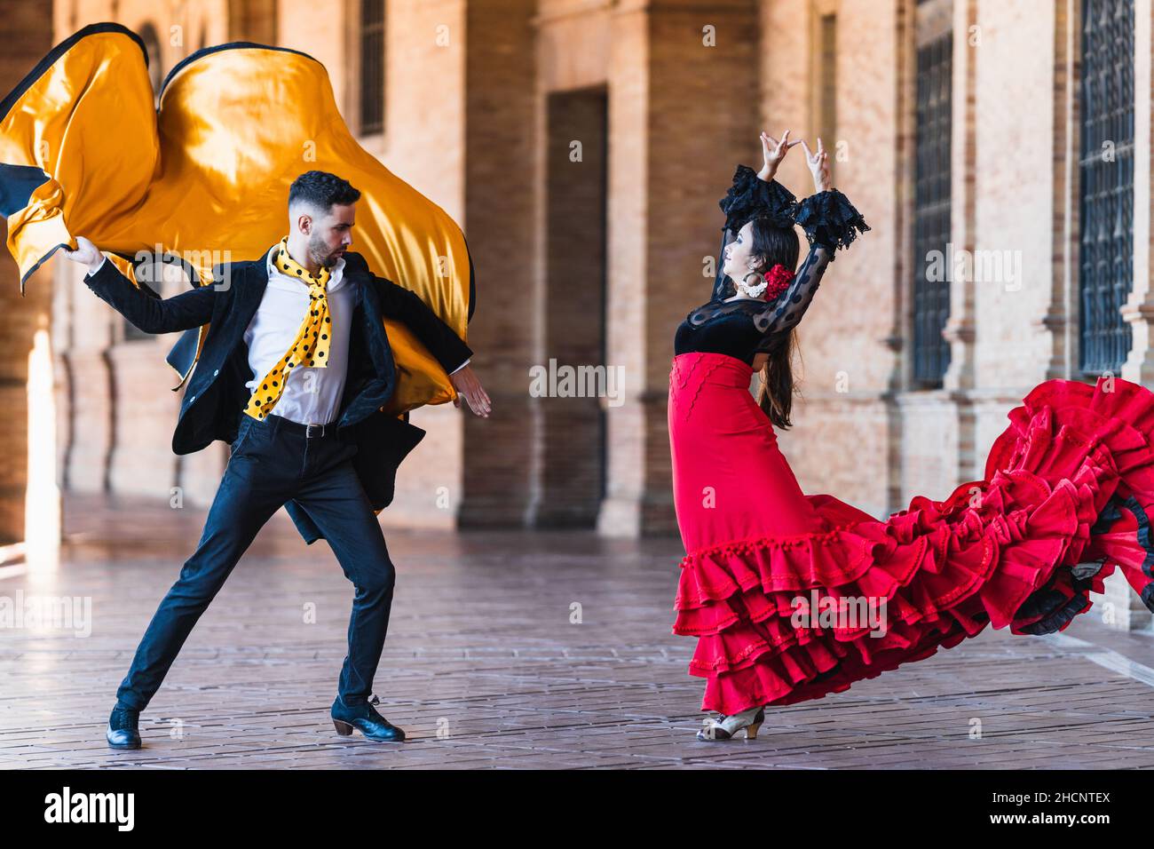 Man with a cloth dancing falmenco with a woman outdoors Stock Photo