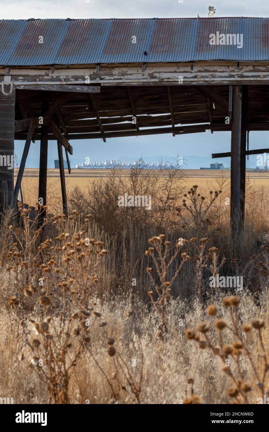 Denver, Colorado - The passenger terminal of Denver International Airport, viewed through an abandoned shed on the prairie east of the airport. Stock Photo